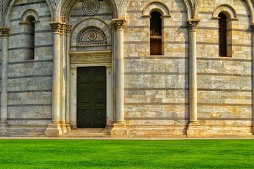 Fototapeta na wymiar A closeup view of the door and the facade of the baptistery in Pisa, Italy