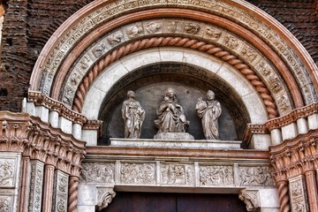 A closeup view of decorative elements of the facade of a cathedral in Bologna, Italy