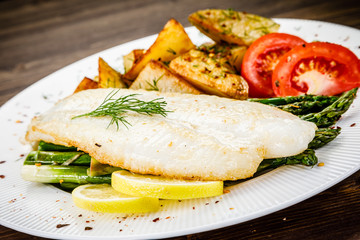 Fish dish - fried fish fillet with fried potatoes and vegetables