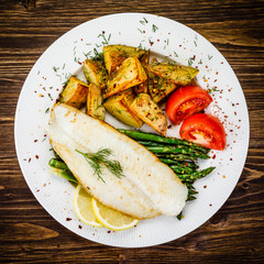 Fish dish - fried fish fillet with fried potatoes and vegetables