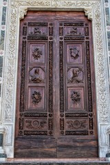A closeup view of the decorations of a closed door in Florence, Italy