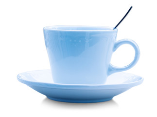 Color ceramic cup with spoon on white background