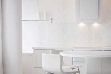 A white and clean home office kitchen   with Scandinavian/Nordic interior style. A glass shelf and a white cooker hood on a background.