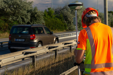 Surveyor with GPS on construction site during the sunny day