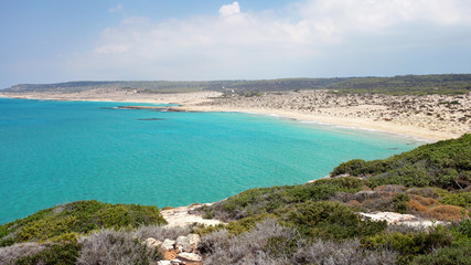 View from hill to beautiful, unspoiled beach, no people, with calm azure sea, Karpass region, Northern Cyprus.