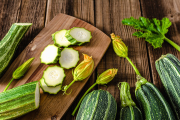 Fresh zucchini slices on kitchen table. Sliced courgette, healthy vegetarian food concept.