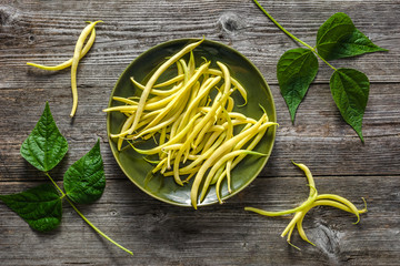 Yellow bean, farm fresh vegetables and organic produce - fresh beans on wooden background