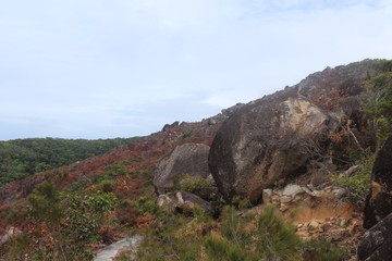 Fototapeta premium Boulders on a red hill