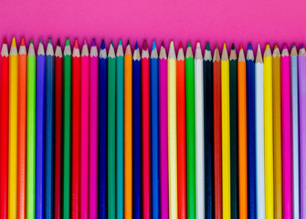 Seamless colored pensils  in a row  on pink  background. Close up. Education, school  concept..