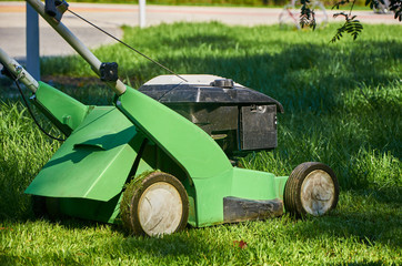 lawn mower stands on the grass