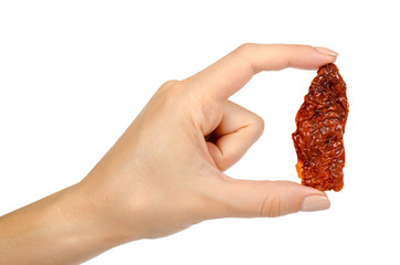 Sun dried red tomatoes with hand isolated on white background