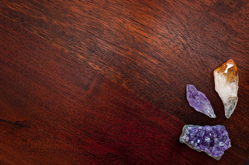 Healing crystals on a table including: Amethyst Point and Cluster, Clear Quartz, Citrine. Gemstones are full of healing energy and good vibes.