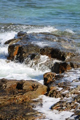 sea foam over red rocks 