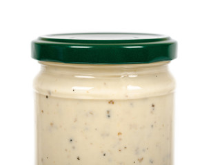 Creamy sauce with truffle for pasta in glass jar isolated on white background