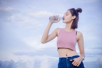 healthy girl's drinking water in the bottle , drink for thirstily for Refreshing