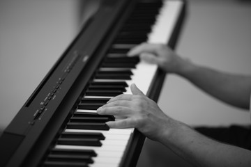 Fototapeta na wymiar Hands of the musical accompanist on the keys of the digital electric piano