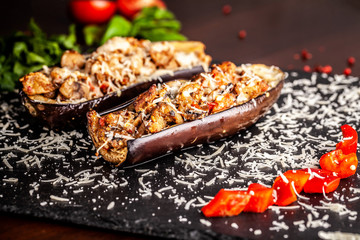 Portuguese cuisine. Baked eggplants with mushrooms, meat, vegetables and parmesan cheese. Copy space, selective focus