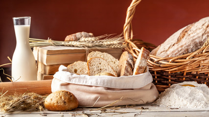 The concept of whole grain bread. Flour and ingredients on a wooden table, bread and rolls from rice, buckwheat flour. Gluten-free bread. Copy space, selective focus