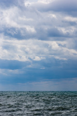 sea landscape is a pebbly beach with waves in white foam