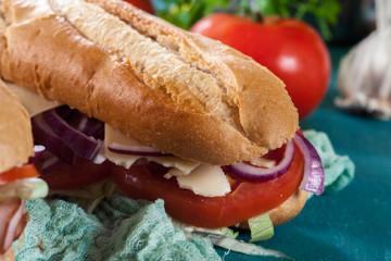 Submarine sandwiches with ham, cheese and vegetables