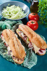 Submarine sandwiches with ham, cheese and vegetables