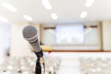 Fototapeta premium Microphone over the blurred business forum Meeting or Conference Training Learning Coaching Room Concept, Blurred background