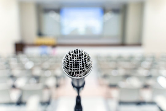 Microphone over the blurred business forum Meeting or Conference Training Learning Coaching Room Concept, Blurred background