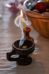 A burning candle on the table