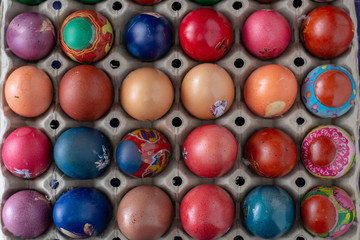 Colorful Easter eggs in egg box.