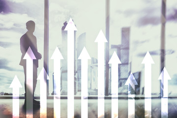 Up arrow graph on skyscraper background. Invesment and financial growth concept.