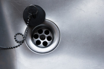 A sink stopper in the metallic aluminium sink to keep water from flowing through the outflow