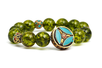 Peridot bracelet Beads green ore lucky stone decorate whit Chakra amulet white white isolated background