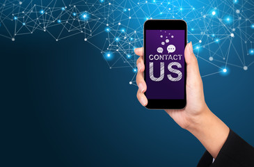 contact us concept. contact us on smartphone screen in businesswoman hand