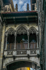 A medieval bridge between building on the quiet narrow streets in the Gothic quarter of Barcelona in the morning - 2