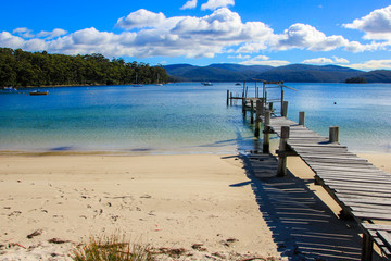 Beautiful Beach with wooden pier into the ocean, Tasmania, Australia