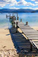 Beautiful Beach with wooden pier into the ocean, Tasmania, Australia