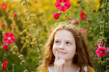 Pensive little girl touching chin with thinking expression face.