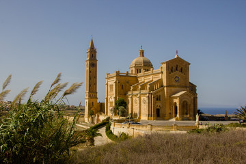 The famous and historical cathedral Ta Pinu on the Maltese island Gozo near Gharb with blue sky
