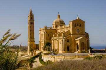 Fototapeta na wymiar The famous and historical cathedral Ta Pinu on the Maltese island Gozo near Gharb with blue sky