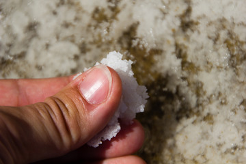 Woman with salt in her hands from the salt pans in Gozo, Malta which is famous for natural salt production