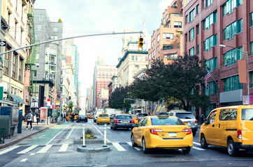 Fototapeta na wymiar Traffic on Manhattan's avenue ( Ladies' Mile Historic District) in the daytime, New York City, United States. Toned image.