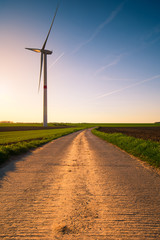Fototapeta na wymiar Windmills at the sunset in the fields