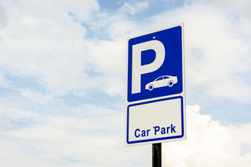 Signs for car park outdoors on the sky background