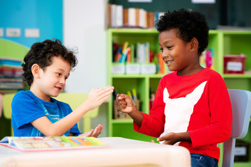 African boy and american boy play togather in library