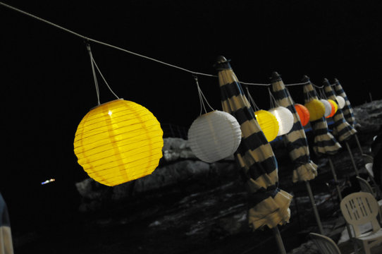 lanterns with candles lit on the beach