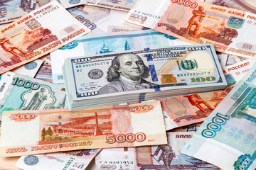 Fototapeta na wymiar Dollars against the background Russian money