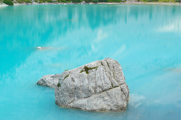 Turquoise colored water of the Sorapis lake, Belluno - Italy