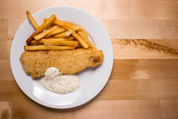 Fish and chips on wooden table with blank space.Flat lay.