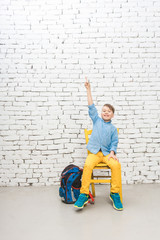 School student boy has an idea raising his arm