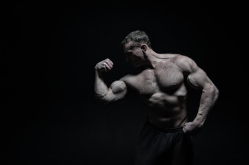 Perfect body. Man bodybuilder posing with tense muscles on black background. Bodybuilder achieved best shape for muscles. Ready for championship. Bodybuilder perfect muscular body, copy space
